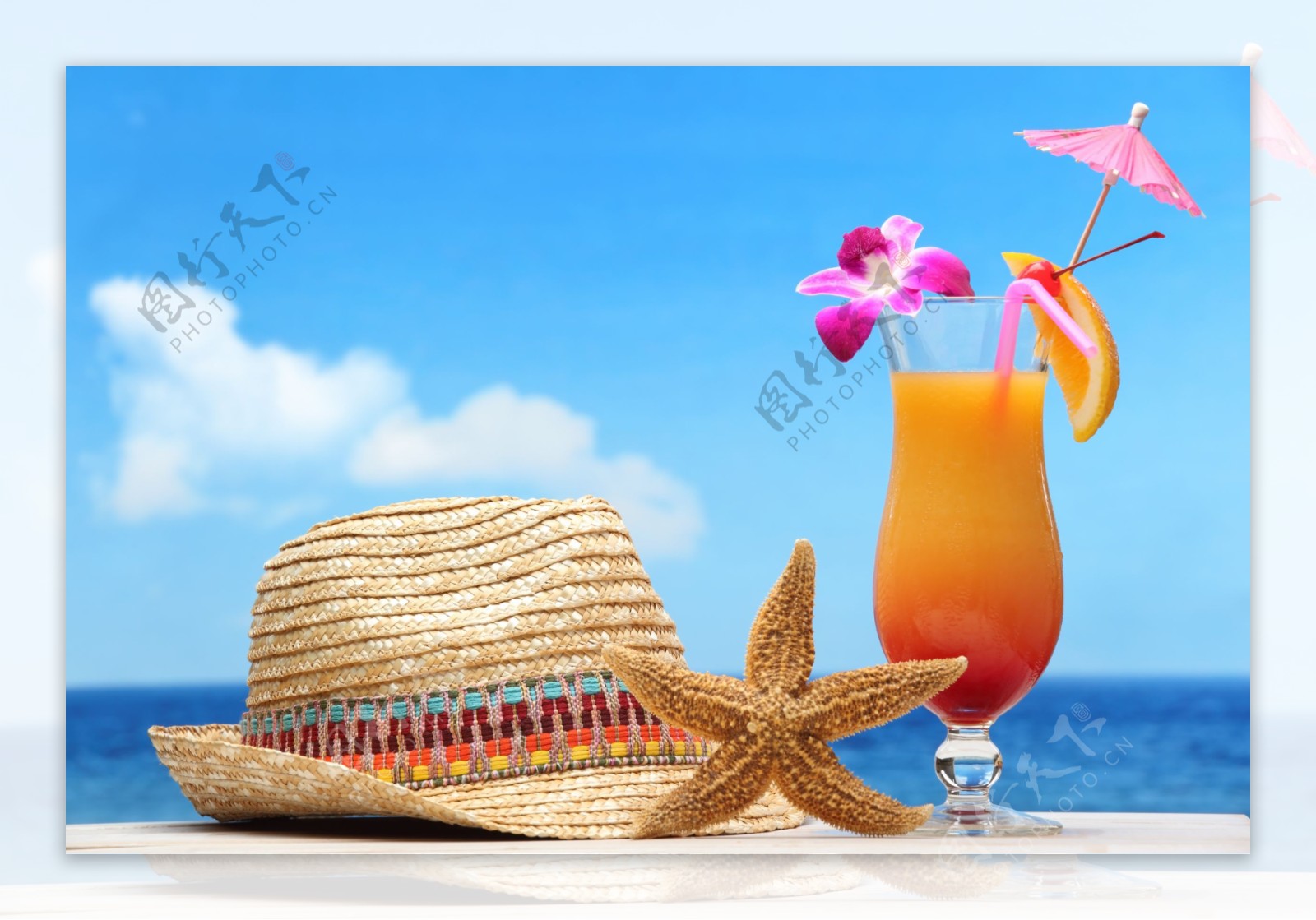 沙滩上的柠檬汁与遮阳帽图片