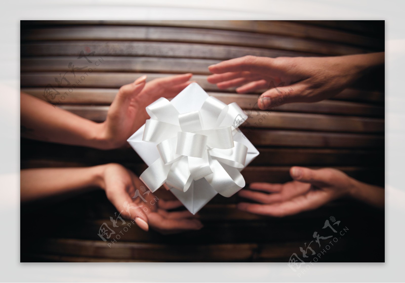 双手和白色礼物盒
